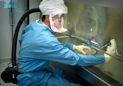 researcher working with ppe on samples