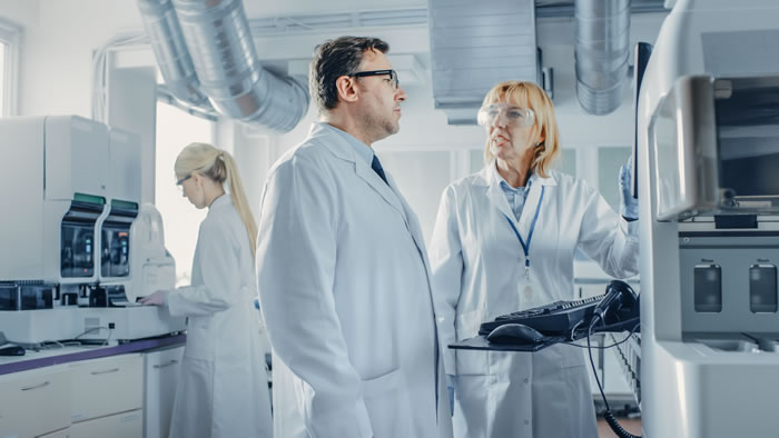 three scientists working in a lab