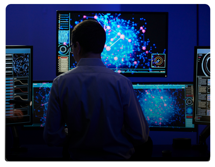 Image of researcher standing in front of computers