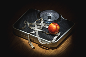 Healthy fruits and weighing machine