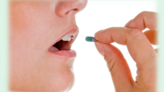 woman taking oral birth control medication