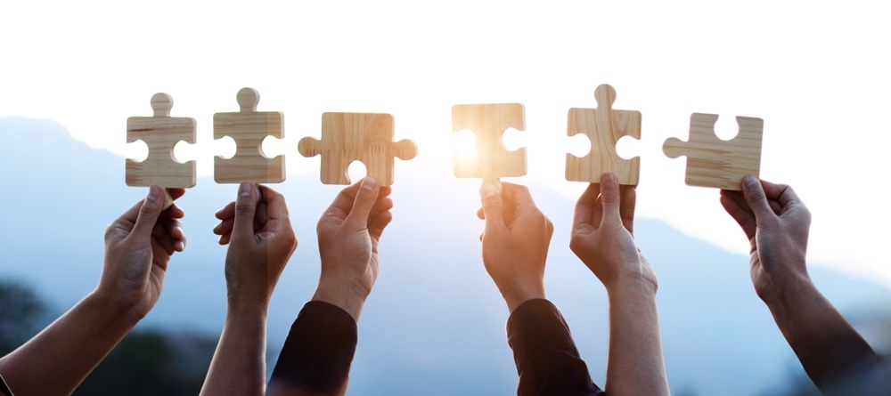 Hands holding pieces of puzzle
